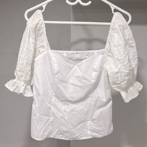Selling my ASOS white top with designed cuffed sleeves .